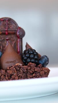 chocolate halloween monument Spooky Halloween chocolate Cake with Skull, Eyeball, and Spider Decoration on dark background 
