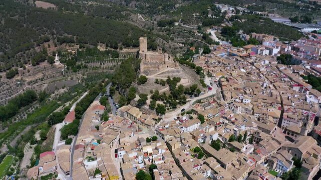 Aerial view of the town of Biar and its defensive castle in a mountain peak in the city center, in Alicante, Spain.
