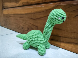 Amigurumi crocheted green dinosaur
