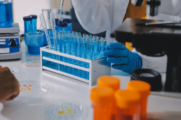 Collaboration, tablet or science with people in lab together for research or development. Innovation, tech and microscope with scientist team in clinical trial for planning or medical investigation