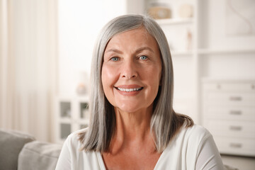 Fototapeta premium Elegant senior woman on sofa at home