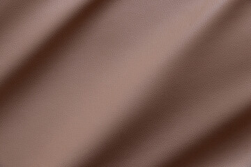Close-up of synthetic brown leather with wavy curves and fine texture as background or wallpaper