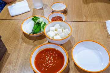 Korean side dish on wooden table in restaurant , Kimchi cabbage,radish and cucumber,Korean food homemade side dish.