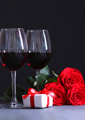 red wine and roses on the table. Valentine's day background.. Vertical photo format