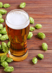Beer, wheat and hops on the table.. Vertical photo format