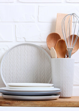 A set of dishes and kitchen utensils on a colored background.. Vertical photo format