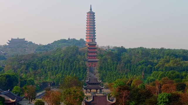 Aerial view of bai dinh pagoda in lush Ninh Binh landscape under blue sky.