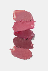 Cosmetic beauty product. Cool nude brown pink blush lipstick set grey isolated background