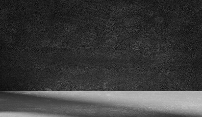 Dark light gray background with cement wall texture. Minimalist abstract background for product presentation with soft shadows from the window.