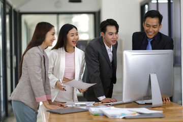 Business meeting, brainstorming colleagues are discussing, planning a business project together on the computer.