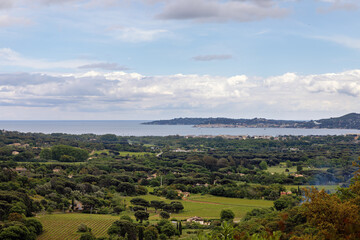 Obraz premium Bay of Saint Tropez, taken from Grimaud in the Massif des Maures mountains, with Port Grimaud and Saint Tropez with the famous church, Cote d'Azur, French Riviera