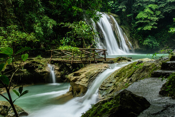 Obraz premium Daranak Falls with Wooden Bridge in Lush Jungle in Tanay, Rizal, Philippines, taken last 2017