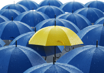 One Yellow Umbrella Among Many Blue Umbrellas