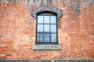 Orange brick wall with classic rectangle style window for background