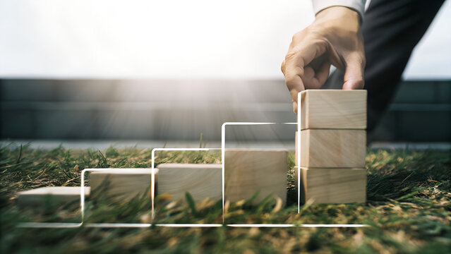 Hand placing wooden cube progress bar concept of transition and planning
