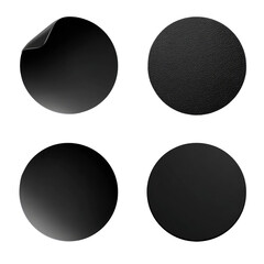 Four circular, black graphic elements, resembling stickers or buttons.  Each circle has a subtle, varied texture or shading, with one sticker showing a detached corner