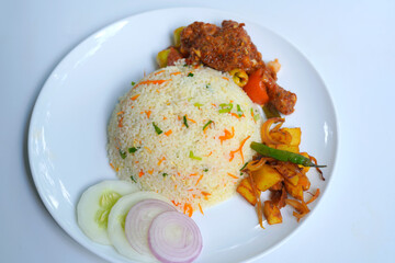 Homemade Fried Rice and Devil Chicken Dish with Onion and Cucumber on White Plate.