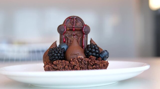 chocolate halloween monument Spooky Halloween chocolate Cake with Skull, Eyeball, and Spider Decoration on dark background 