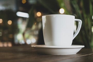 Hot coffee in white mug with dark backdrop. Freshly brewed coffee against black background. Cup of coffee on dark background.