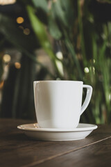 Hot coffee in white mug with dark backdrop. Freshly brewed coffee against black background. Cup of coffee on dark background.