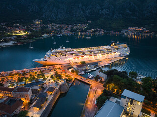 Big Cruise Ship in Kotor on the coast of Boka bay in Mediterranean, Montenegro. Destination in Europe. Aerial