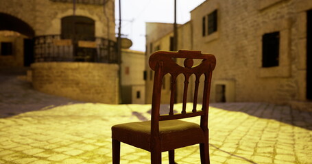 A wooden chair stands alone in the middle of a cobblestone street. Ancient buildings surround it, illuminated by warm sunset light. The quiet ambiance evokes a sense of nostalgia.