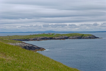 The view across the Eye Peninsula at Tiumpan Head to the small Fishing Village of Portnaguran on the Isle of Lewis in overcast conditions.