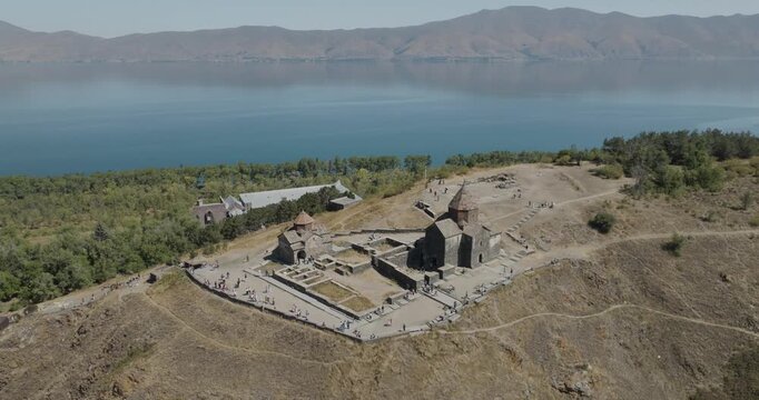 Aerial view of the ancient Sevanavank Monastery atop a hill, contrasting with the deep blue waters of Lake Sevan, Lake Sevan, Gegharkunik Province, Armenia.