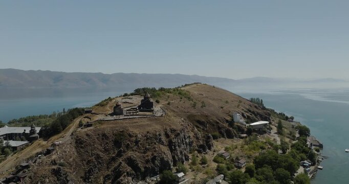 Aerial view of the historic Sevanavank Monastery perched atop a hill with the contrasting blues of Lake Sevan in the background, Lake Sevan, Gegharkunik Province, Armenia.