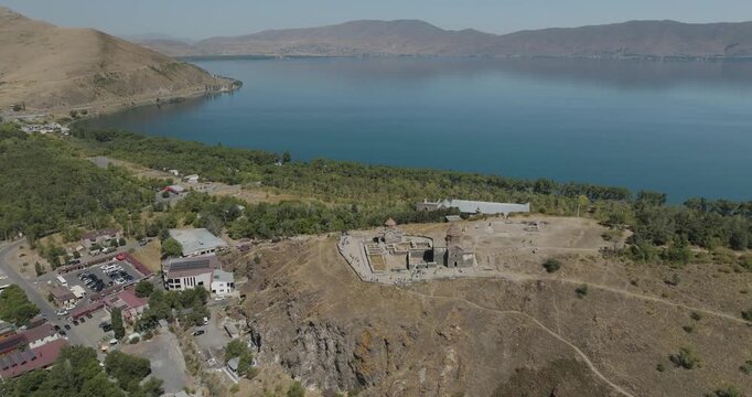 Aerial view of Sevanavank Monastery perched on a hill overlooking the serene blue waters of Lake Sevan, with lush greenery surrounding it, Lake Sevan, Gegharkunik Province, Armenia.