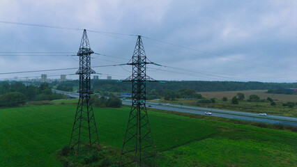 High Voltage Power Lines over Highway - Aerial Drone View