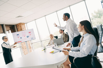 Fototapeta premium Diverse Group of Business Professionals Discussing Project Strategies in a Modern Office Setting