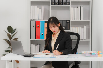 Asian Businesswoman Working at Desk in Office