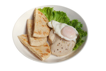 Healthy meal with pita dough bread served with sliced chicken breast sprinkled with black pepper, and a sunny-side-up egg with a soft yolk.