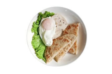 Healthy meal with pita dough bread served with sliced chicken breast sprinkled with black pepper, and a sunny-side-up egg with a soft yolk.