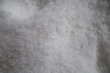 Close-up of a pile of coarse white salt crystals.