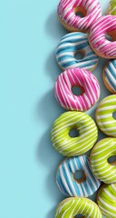 Stacked colorful striped donuts against light blue background