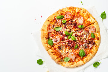Delicious meat pizza with ham, salami and sausages.