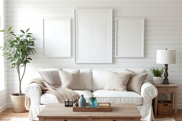 Bright modern farmhouse living room interior with a comfortable white slipcover sofa, wooden furniture, and blank frames on a shiplap wall.