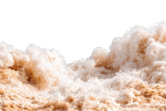 Close-up of frothy, tan-colored water cascading over a riverbank