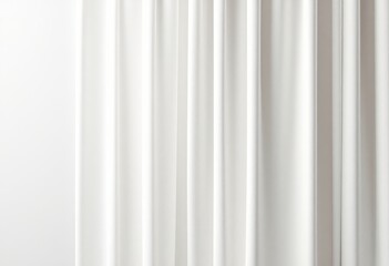 White curtains hang in soft folds against a bright backdrop, creating a serene and elegant interior design element.