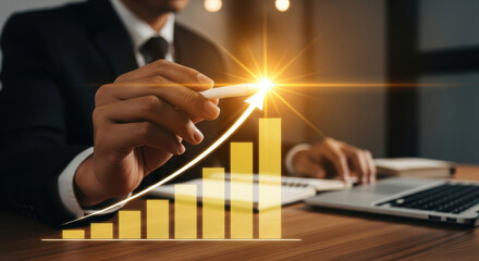 A businessman hand holding pen drawing glowing upward arrow on bar graph, symbolizing financial growth, success, and positive business trend in modern office environment