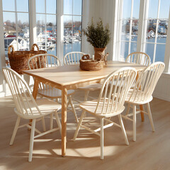Wooden dining table with six white chairs in a sunlit room overlooking a harbor.