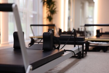 Three reformers in studio, closeup. Pilates equipment