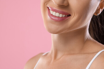 Woman with beautiful healthy teeth on pink background, closeup. Space for text