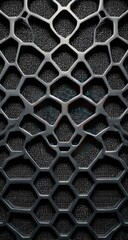 Close-up view of a dark gray, intricate, hexagonal mesh pattern.  The pattern appears three-dimensional, with a slightly recessed, honeycomb-like structure.  Dark gray background