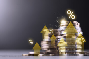 Coins with arrows and percent signs on table against grey background