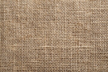 Close-up view of a natural beige burlap fabric.  The tightly woven texture creates a grid pattern