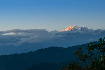Beautiful last light from sunset on Mount Kanchenjugha, Himalayan mountain range, Sikkim, India. color tint on the mountains at dusk