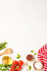 Spices, herbs and vegetables with olive oil on white kitchen table.